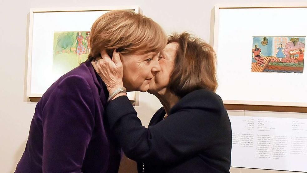 Left to right: Chancellor Angela Merkel with survivor artist Nelly Toll at the exhibition opening. Photo courtesy DPA